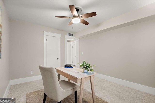 office featuring baseboards, visible vents, ceiling fan, and carpet flooring