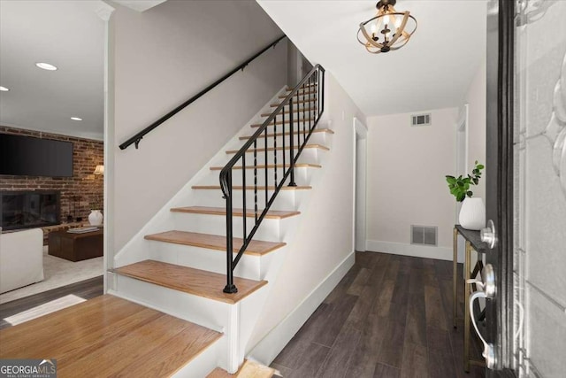 entrance foyer with stairs, wood finished floors, and visible vents