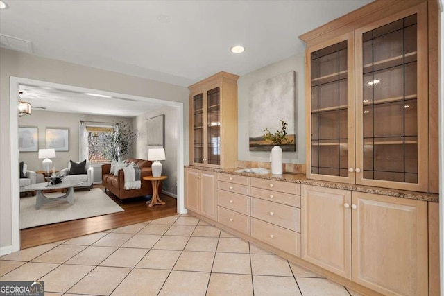 interior space featuring light tile patterned floors, baseboards, and recessed lighting