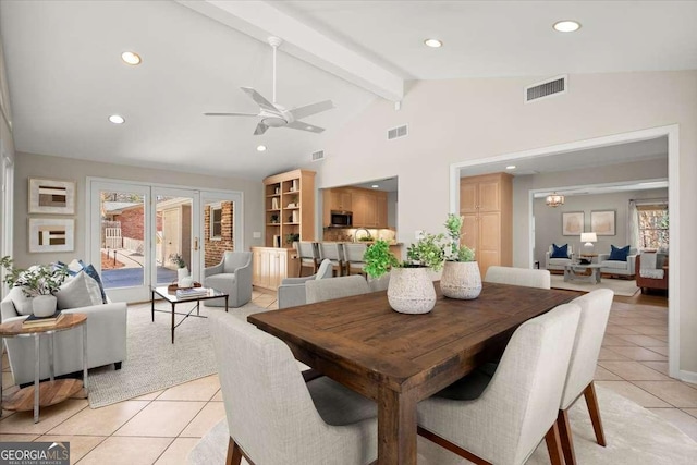 dining area with a healthy amount of sunlight, visible vents, and beamed ceiling