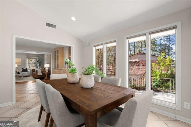 dining space with light tile patterned floors, recessed lighting, visible vents, vaulted ceiling, and baseboards