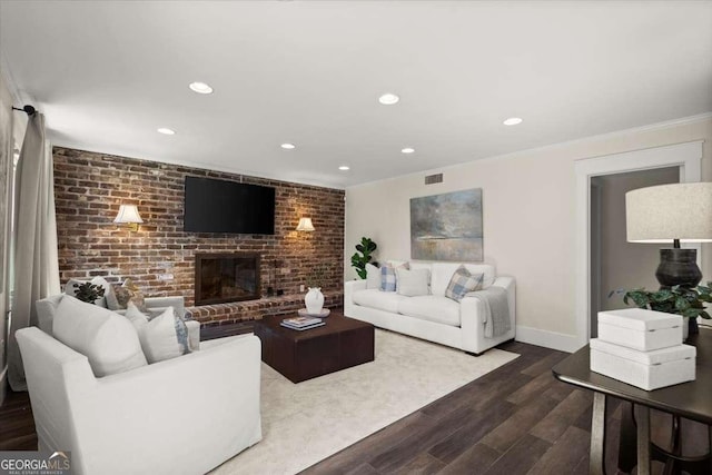 living area featuring dark wood-style floors, a fireplace, recessed lighting, visible vents, and baseboards