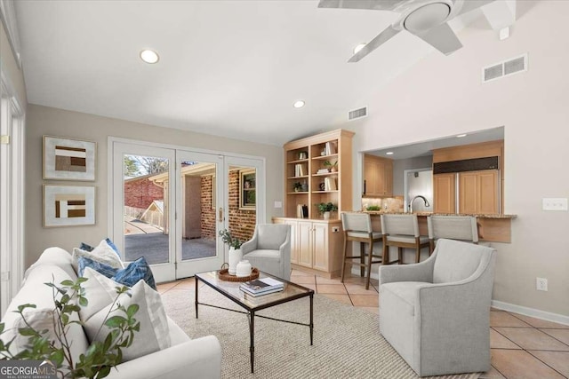 living area with light tile patterned floors, visible vents, and a ceiling fan