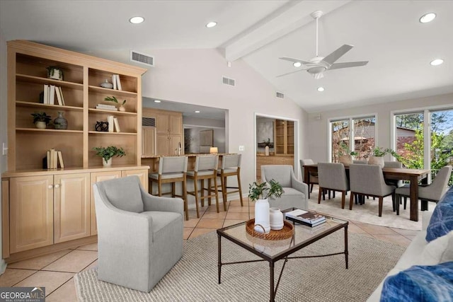 living area with light tile patterned floors, beam ceiling, and visible vents