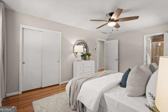 bedroom featuring ceiling fan, a closet, baseboards, and wood finished floors