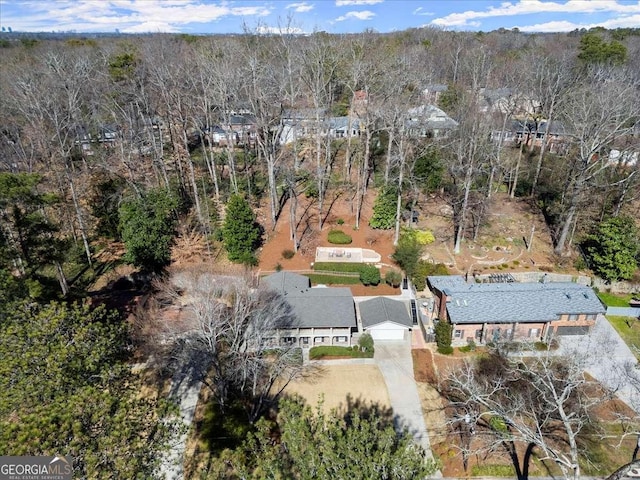 birds eye view of property with a wooded view