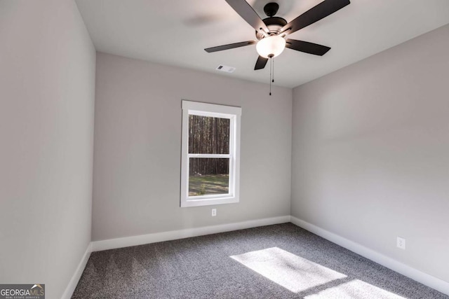 empty room featuring a ceiling fan, carpet, visible vents, and baseboards