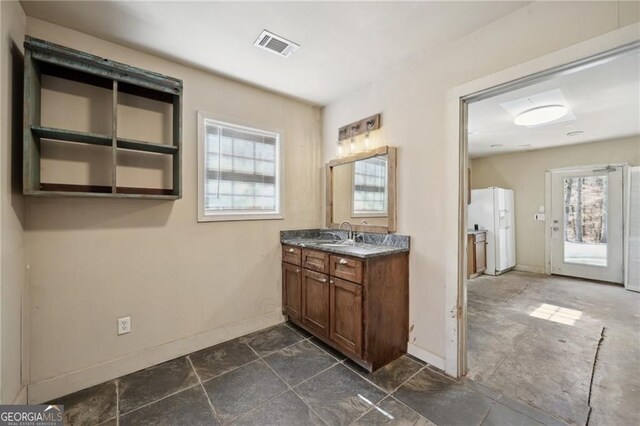 3630 Jim Moore Rd, Dacula, GA 30019 - kitchen with brown cabinetry, dark countertops, black range with electric stovetop, under cabinet range hood, and a sink
