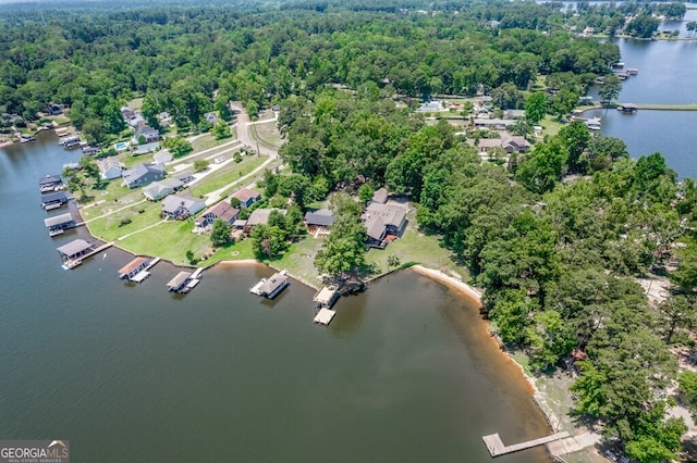 aerial view with a water view and a forest view