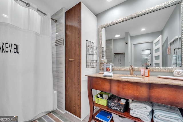 full bathroom with a shower with curtain and vanity