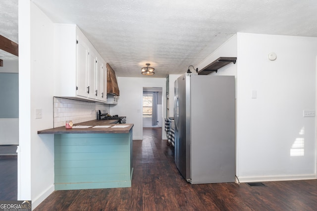 kitchen featuring stainless steel appliances, white cabinets, dark wood finished floors, and tasteful backsplash