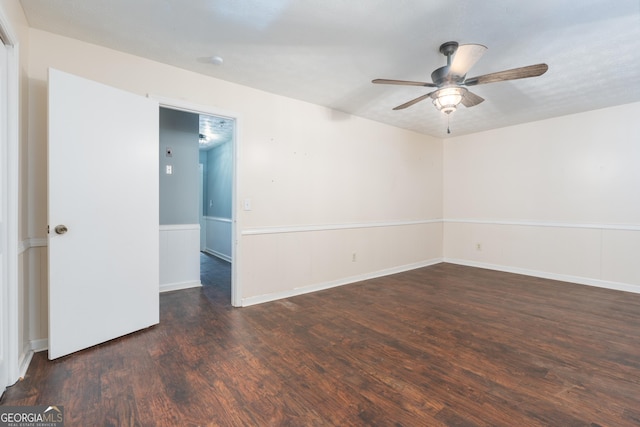 unfurnished room with wainscoting, wood finished floors, and a ceiling fan