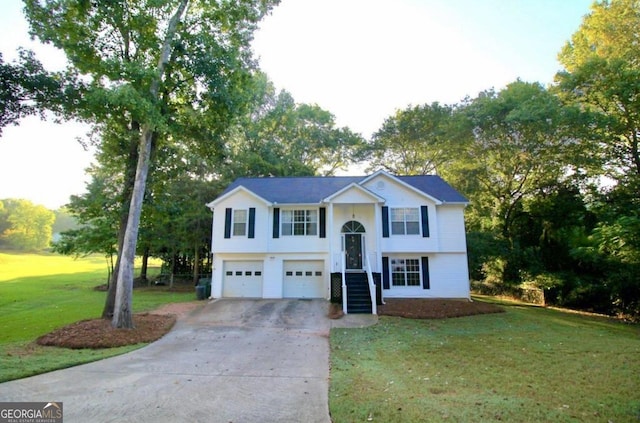 split foyer home with a front yard, concrete driveway, and an attached garage