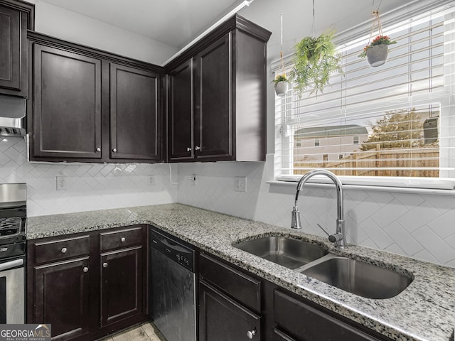 kitchen with appliances with stainless steel finishes, decorative backsplash, and a sink