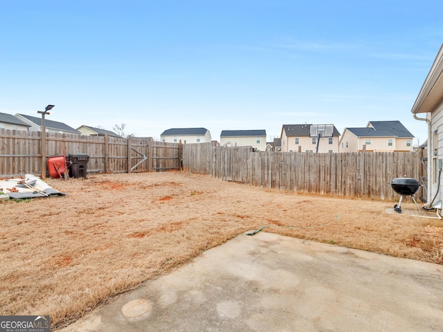 view of yard with a patio area and a fenced backyard