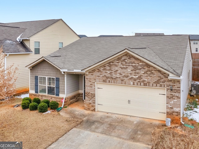 view of front of house with a garage, concrete driveway, brick siding, and a shingled roof