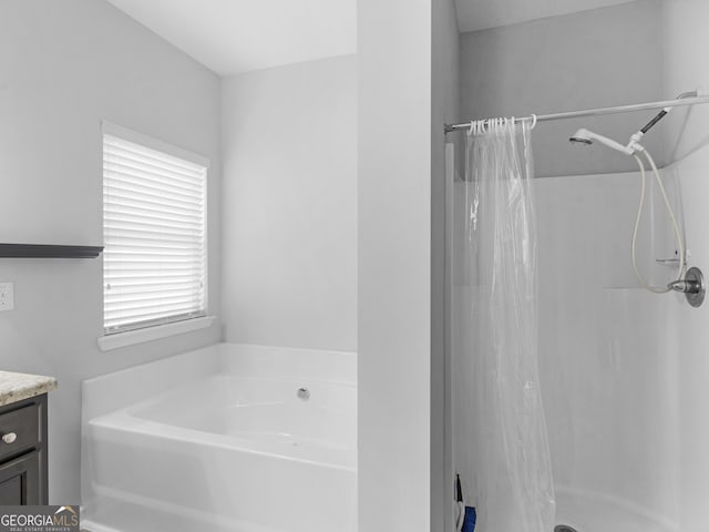 full bathroom featuring a shower stall, a bath, and vanity