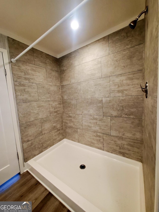 bathroom featuring a stall shower and wood finished floors