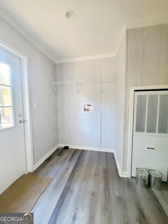 clothes washing area with washer hookup, laundry area, a heating unit, and wood finished floors