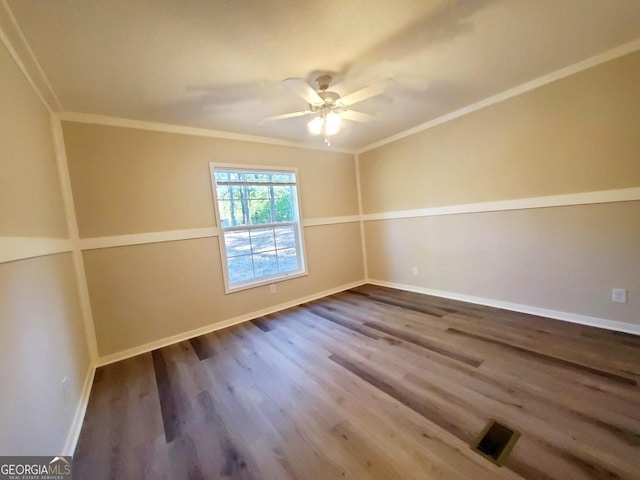 unfurnished room with dark wood-style floors, visible vents, ornamental molding, a ceiling fan, and baseboards