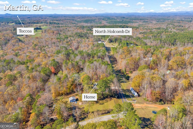 drone / aerial view featuring a forest view