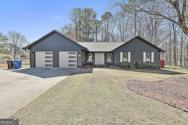 view of front of house featuring an attached garage, fence, concrete driveway, roof with shingles, and a front lawn