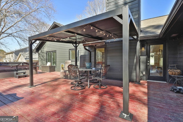 view of patio featuring outdoor dining area, a hot tub, and a deck