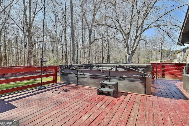 wooden deck with a hot tub