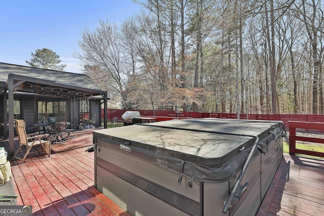 deck with fence and a hot tub