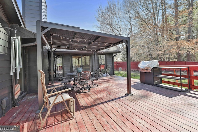 wooden deck featuring grilling area and fence