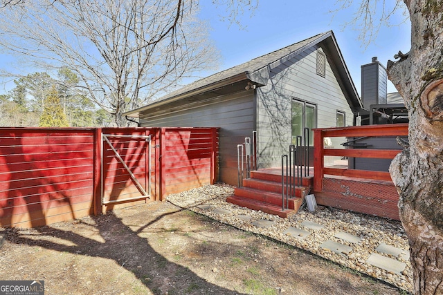 view of home's exterior featuring a gate and fence