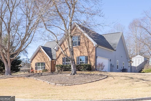 view of front of house featuring central AC, brick siding, a shingled roof, and driveway