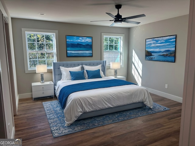 bedroom with wood finished floors, a ceiling fan, and baseboards