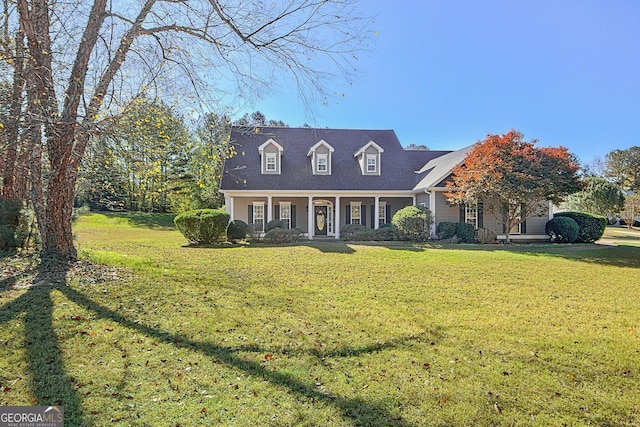 cape cod house featuring a front lawn