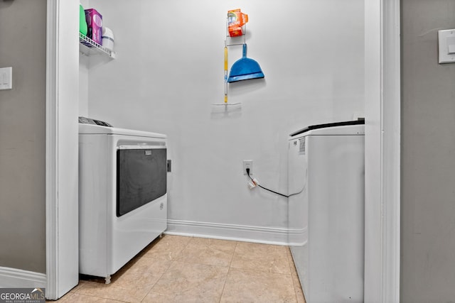 laundry room with laundry area, tile patterned flooring, baseboards, and separate washer and dryer