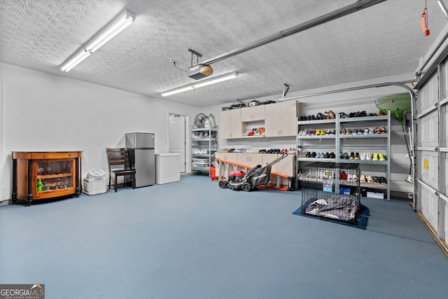 garage with a garage door opener and freestanding refrigerator