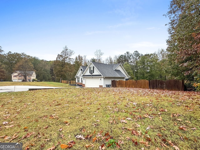 view of property exterior with fence and a lawn