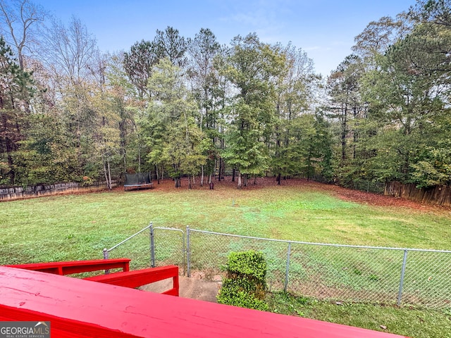 view of yard with a fenced backyard and a trampoline