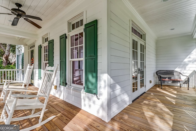 deck with covered porch, french doors, and a ceiling fan