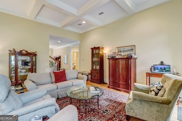 living room featuring visible vents, coffered ceiling, stairway, light wood-type flooring, and beam ceiling