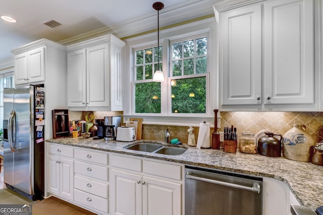 kitchen featuring visible vents, white cabinets, a sink, stainless steel appliances, and backsplash