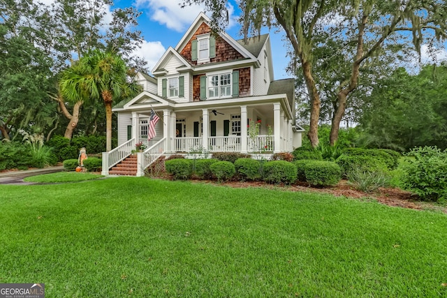 view of front facade with a porch, a front lawn, and a ceiling fan