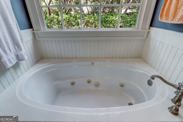 full bathroom featuring a jetted tub