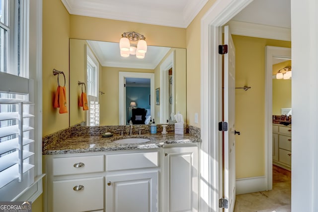 bathroom featuring crown molding and vanity