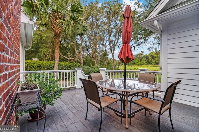 wooden terrace featuring outdoor dining space