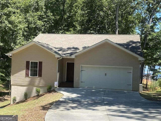 ranch-style home with a garage and concrete driveway