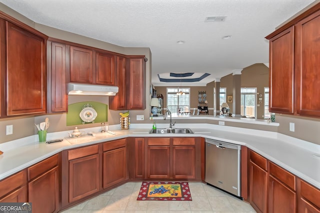 kitchen featuring a textured ceiling, a sink, visible vents, light countertops, and stainless steel dishwasher