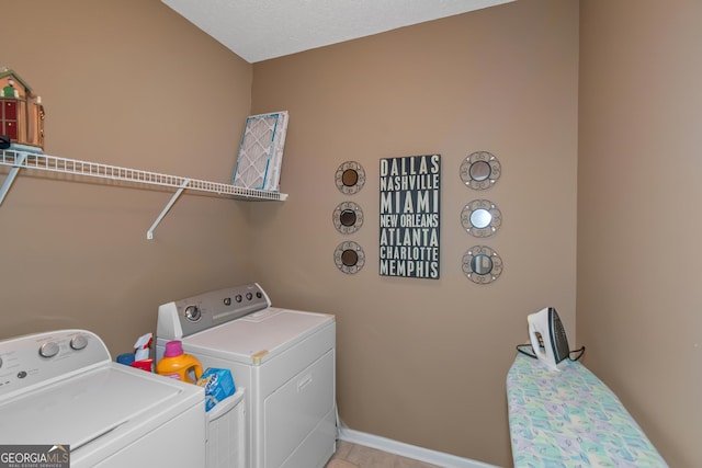 laundry area with laundry area, baseboards, and separate washer and dryer