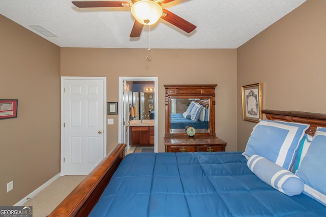 bedroom featuring carpet flooring, connected bathroom, a textured ceiling, and baseboards