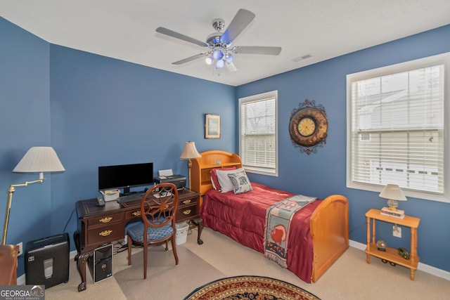 carpeted bedroom featuring baseboards, visible vents, and ceiling fan